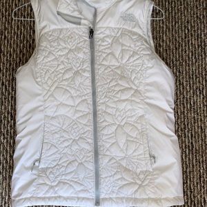 White pattern north face vest.